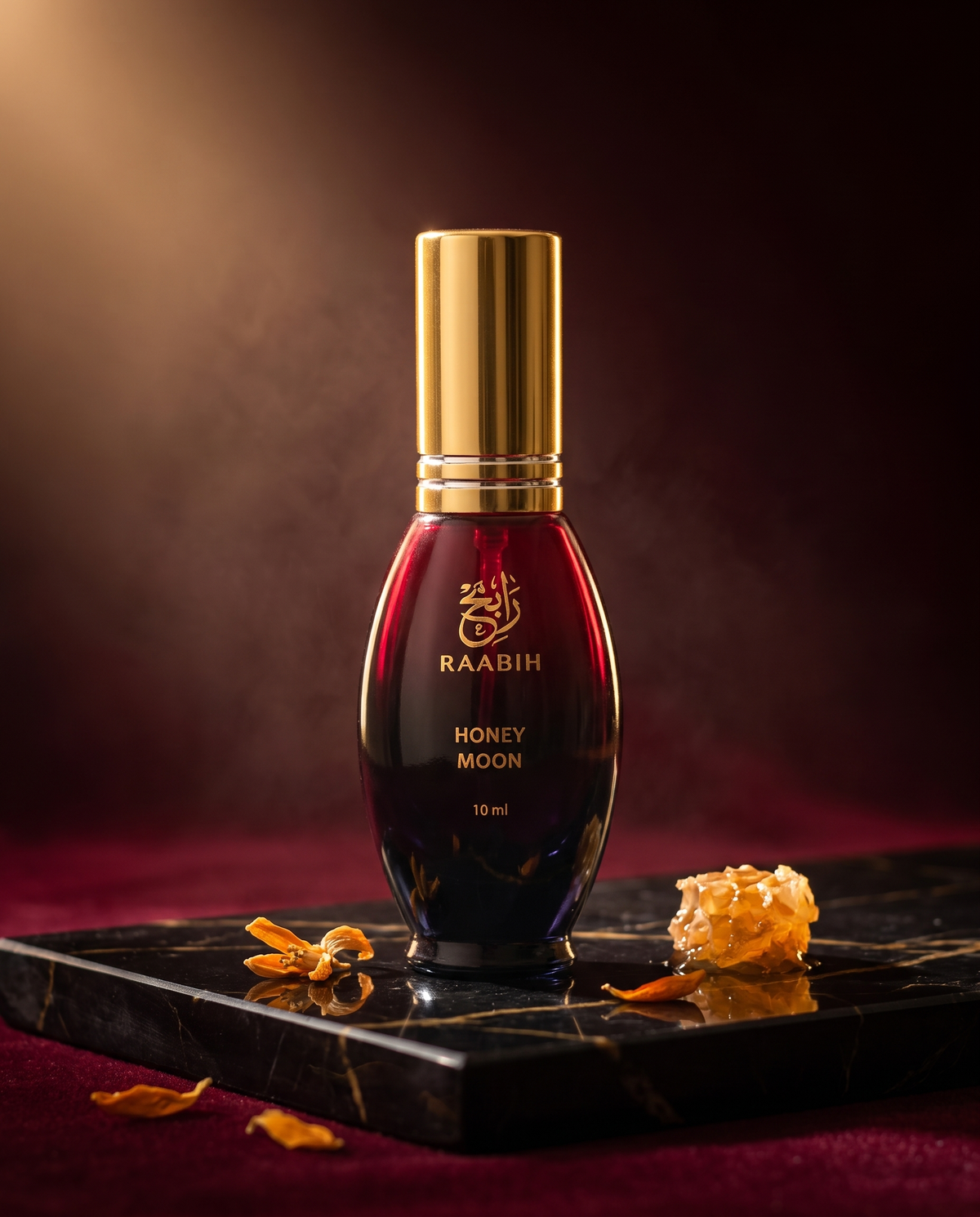RAABIH Honey Moon 10ml oil parfum — crimson flacon on black marble with honeycomb and orange blossom